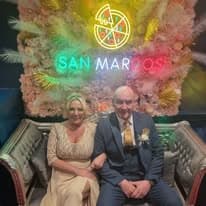 Guests seated in front of the San Marcos neon sign
